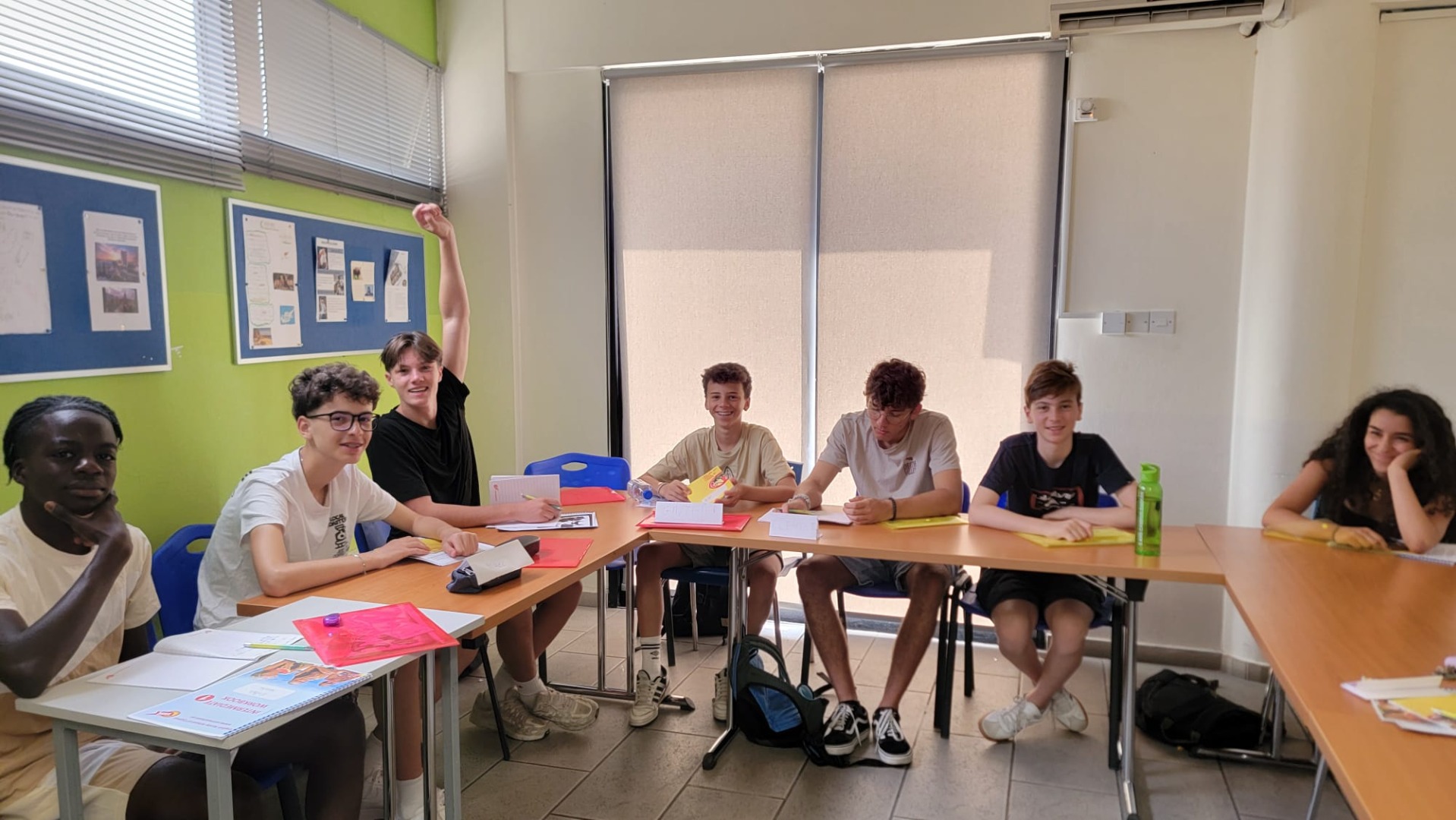 Adolescents assis en classe, souriants et motivés, pendant un cours d’anglais à Chypre.