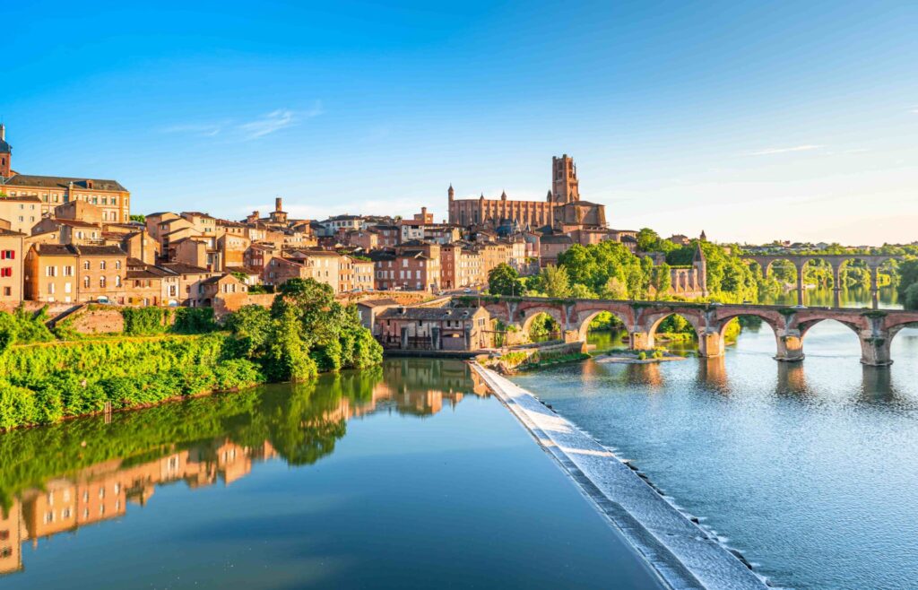 Panoramic view of the historic city of Albi with the Tarn River and Sainte-Cécile Cathedral in southern France.