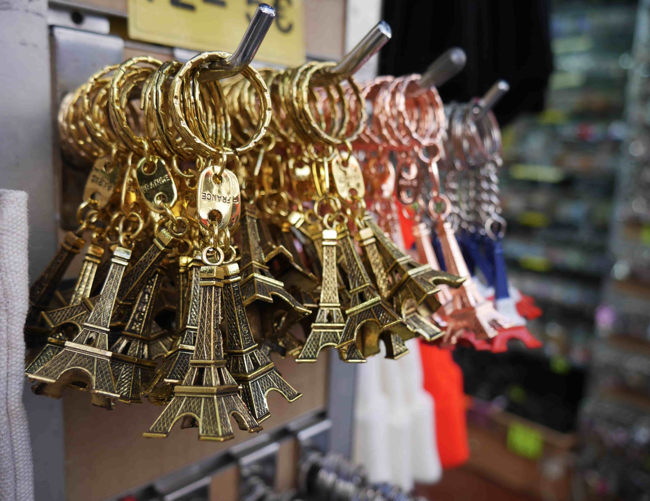 Display of Eiffel Tower keychains, representing popular souvenirs from France to bring home a piece of their adventure.