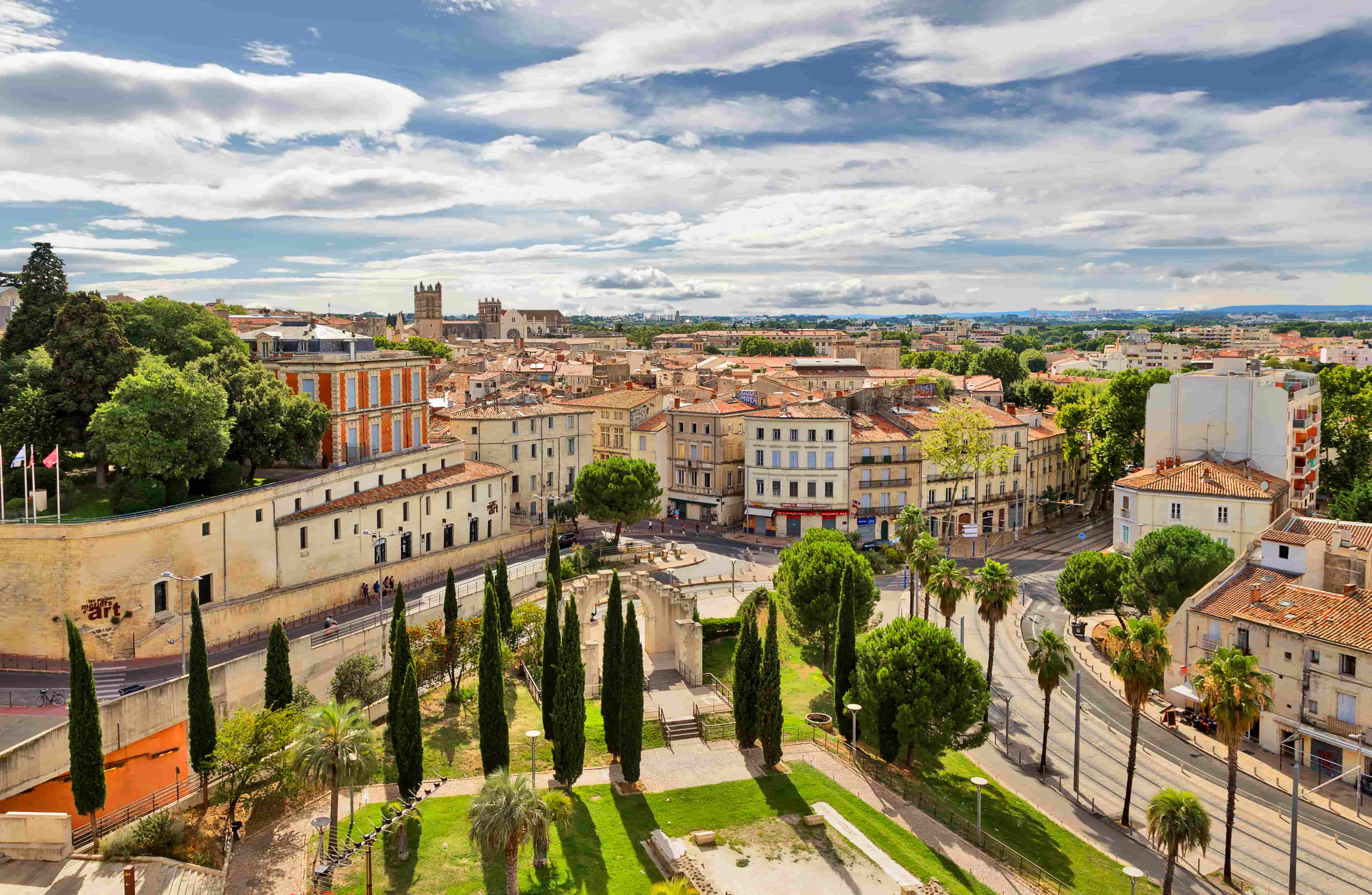 Panoramic view of Montpellier with historic buildings, churches, and tree-lined streets — perfect setting for an international camp.
